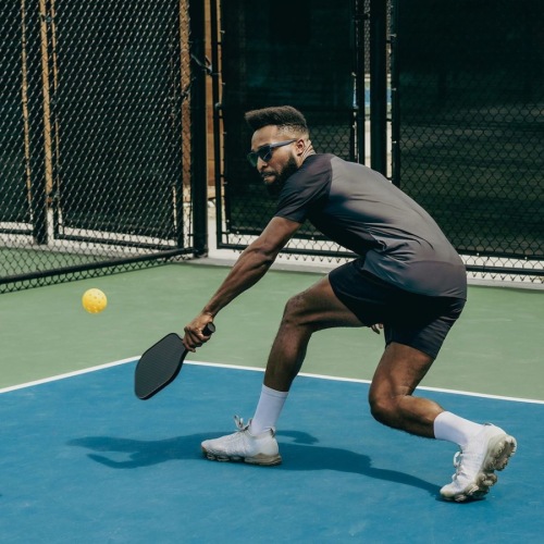 a man playing pickleball