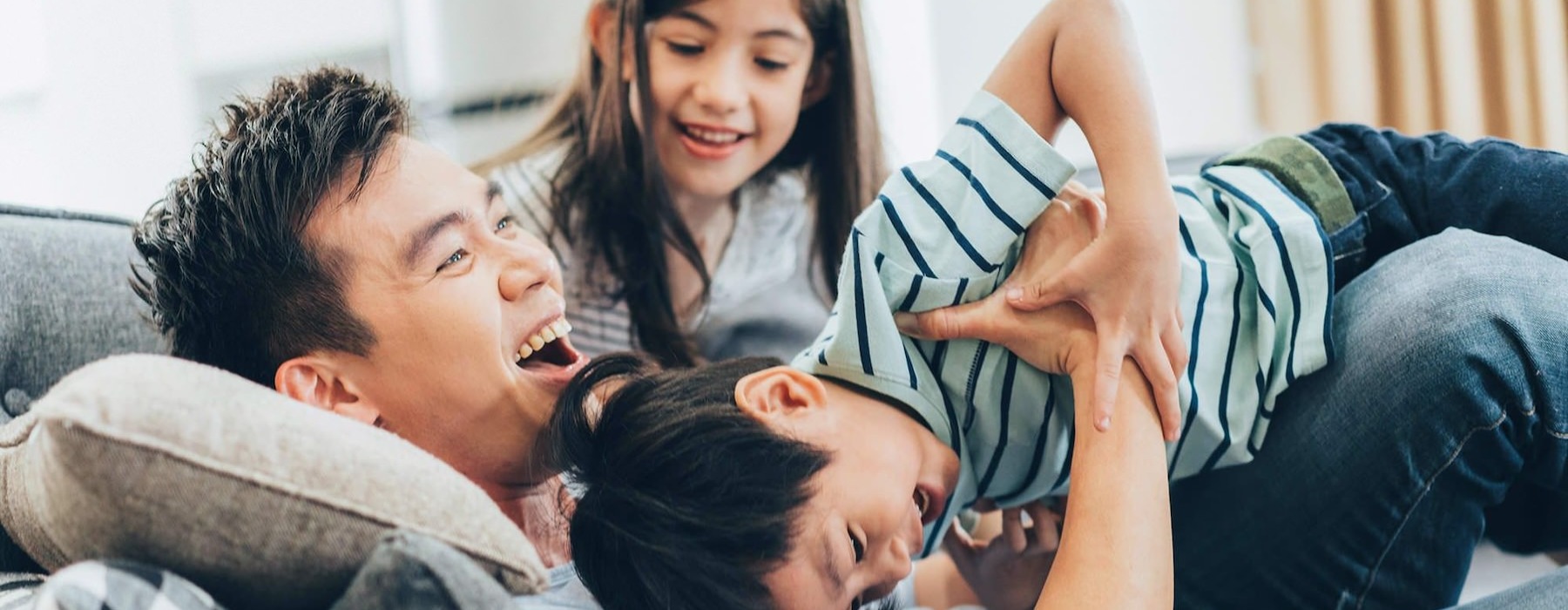 a family playing on a couch